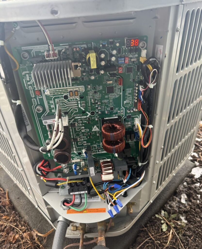 Air conditioning control board inspected during AC repair