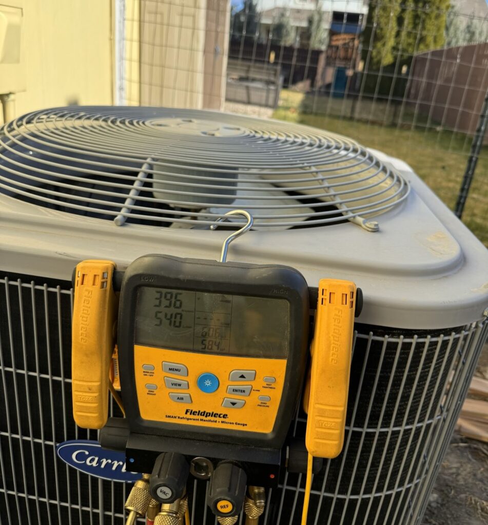 Outdoor air conditioning unit during AC repair service by AirCare HVAC.
