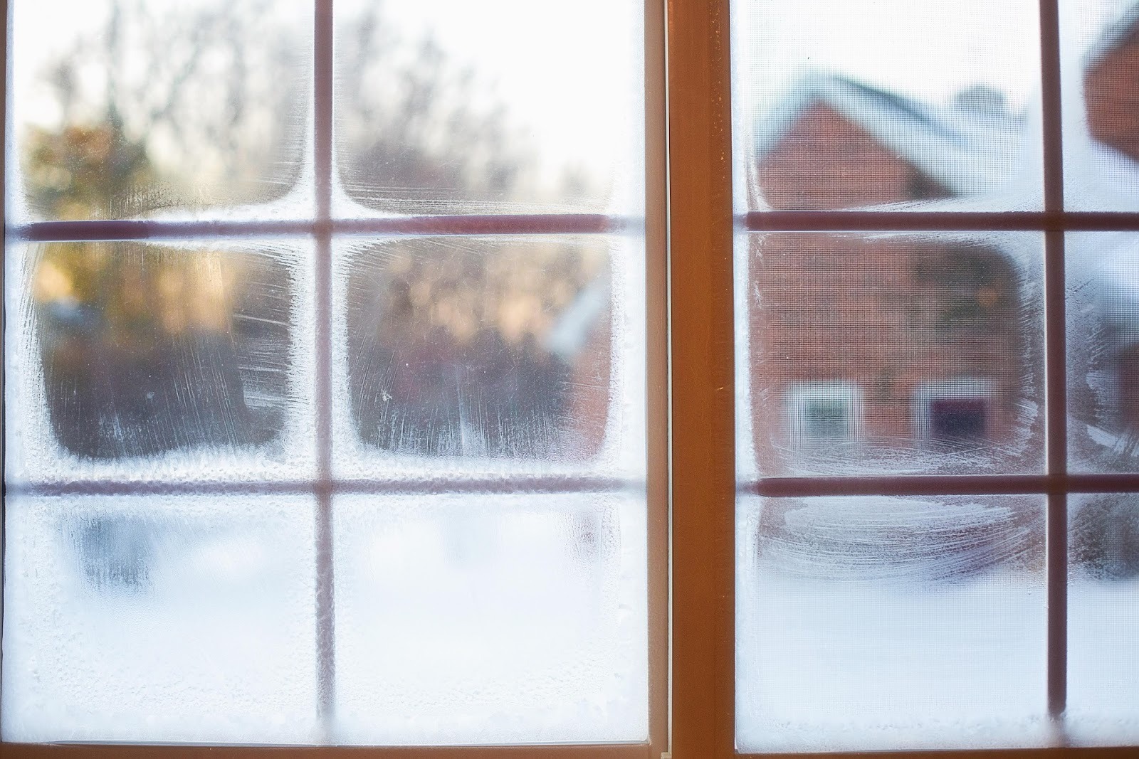 Frosted window during winter showing conditions that affect indoor air quality