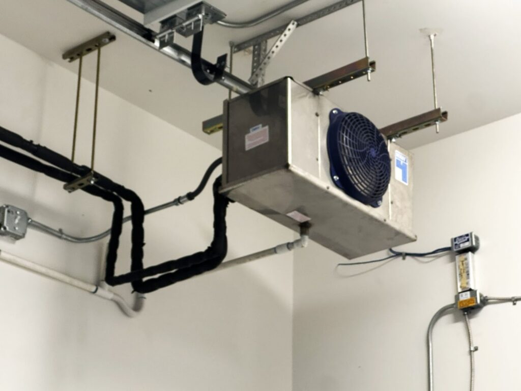 Indoor AC system installation showing ductwork and mounted equipment