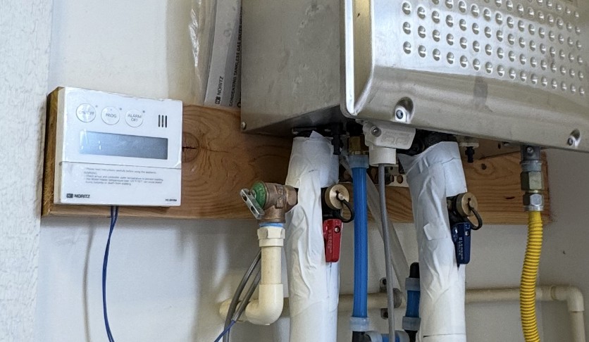 Home thermostat installed on wall to adjust heating and cooling settings throughout the day