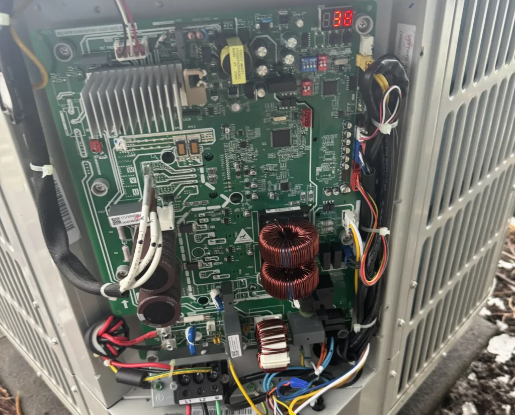 AirCare technician's AC repair work on an open condenser control board in West Richland, WA.