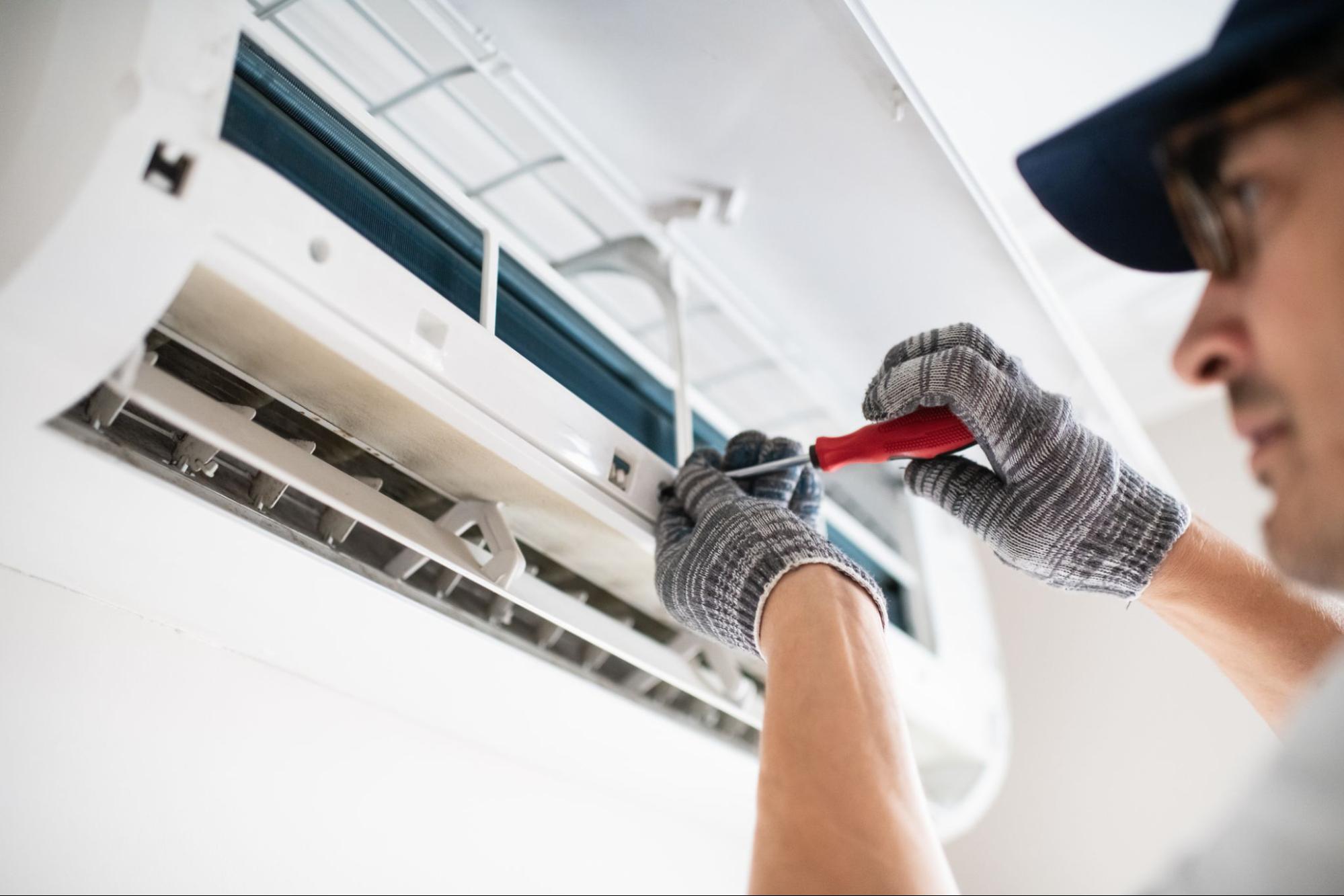 HVAC technician installing a wall-mounted ductless mini split unit in a Richland home.